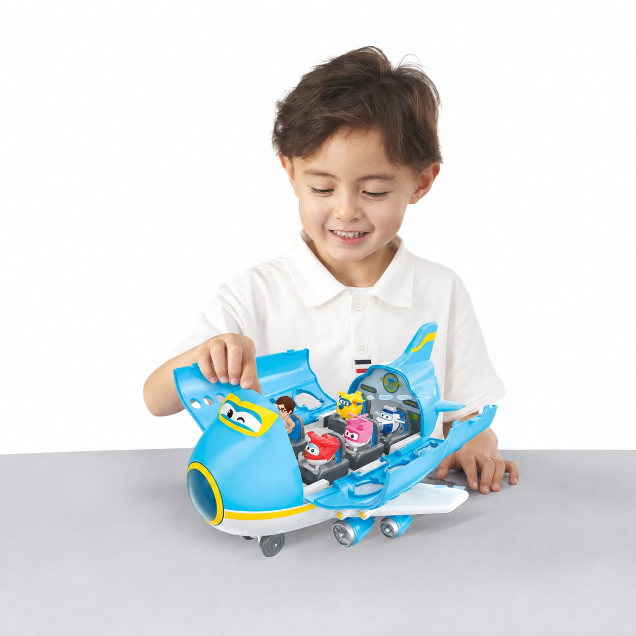 Child playing with Super Wings Big Wing Museum Adventure aircraft playset and included figures